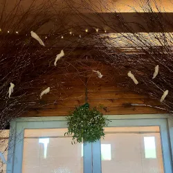 A mistletoe ball hangs above the entrance to a wedding venue