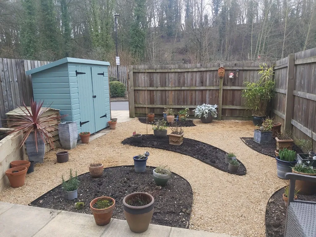 The same space but with curved beds and gravel paths between them