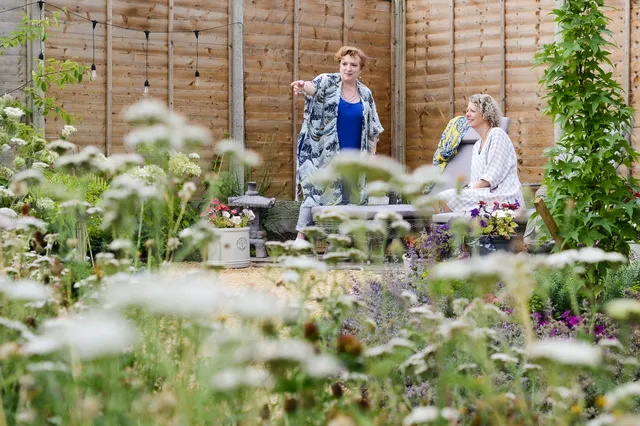 Charlotte explains things to a client in her garden. Photo by Victoria Tapper